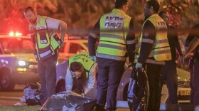 Israeli security forces inspect the crime scene in Jaffa after a Palestinian stabbed and killed an American on March 8. The attacker was shot and killed by a volunteer policeman.