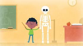 Cartoon boy standing next to a skeleton in a classroom. 