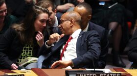 US Deputy Ambassador to the UN Robert Wood talks with his staff during a United Nations Security Council meeting on a resolution calling for a ceasefire in Gaza at UN headquarters in New York.