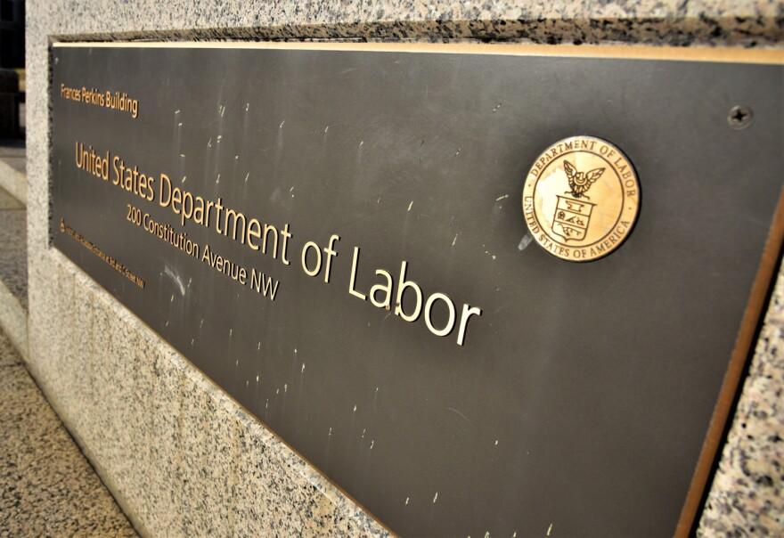 A placard in front of the U.S. Department of Labor. A proposed mandate would have Occupational Safety and Health Administration enforce a requirement that businesses with 100 or more employees be vaccinated or get tested weekly.