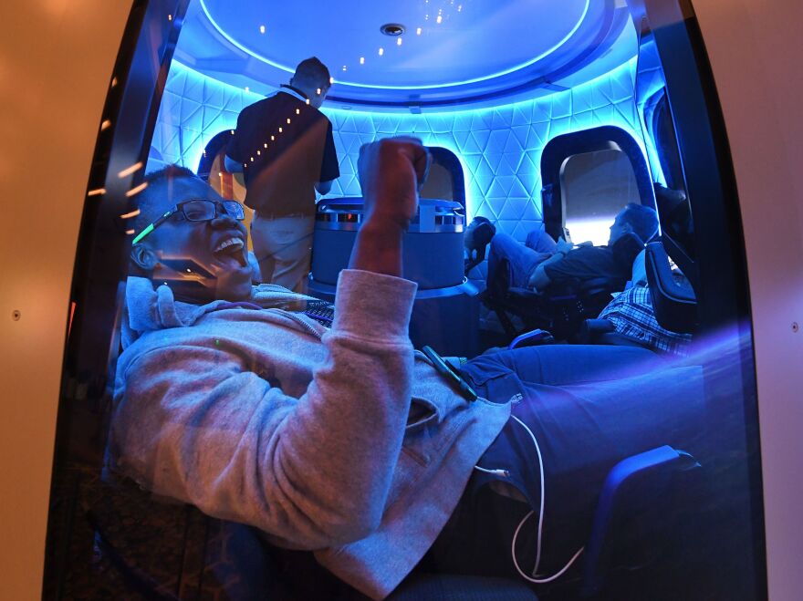 Participants enjoy the Blue Origin Space Simulator during the Amazon Re:MARS conference on robotics and artificial intelligence at the Aria Hotel in Las Vegas, Nevada on June 5, 2019. (Photo by Mark RALSTON / AFP) (Photo by MARK RALSTON/AFP via Getty Images)