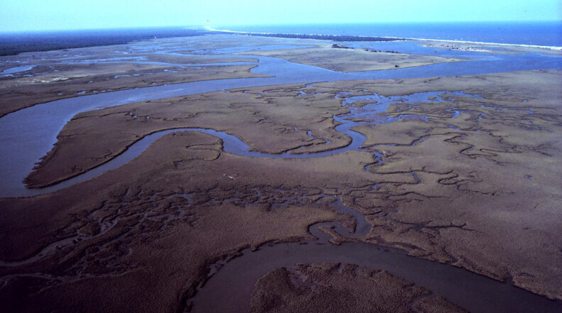 North Inlet - Winyah Bay National Estuarine Research Reserve. Aerial view of meandering tidal creeks and extensive pristine marshes in North Inlet Estuary. Vicinity of Georgetown, South Carolina.