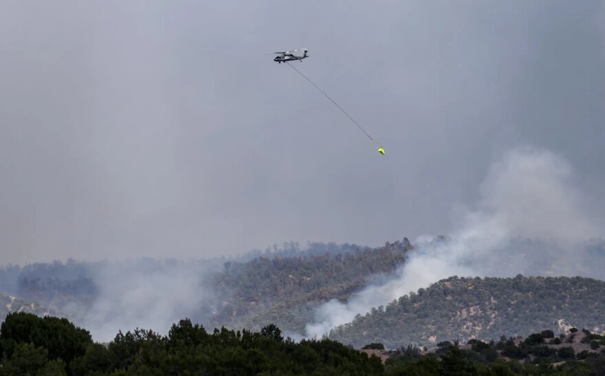Firefighting aircraft battle the Frijoles Fire in the Pecos Wilderness on Aug. 12. The blaze has now grown to more than 11,000 acres.