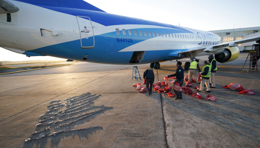 Personal belongings of immigrants who entered the United States illegally are loaded onto a plane for a deportation flight to El Salvador by U.S. Immigration and Customs Enforcement Friday, Nov. 16, 2018, in Houston. 