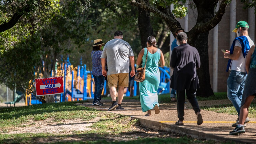 Voters approach a polling location in Austin, Texas, on Oct. 13 — the first day of voting in the state. Nearly 10 million ballots have already been cast in Texas — more than 2016's total votes in the state.