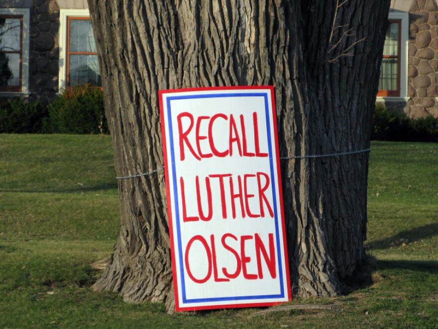 A large sign urging the recall of Republican state Sen. Luther Olsen is tied around a tree in Montello, Wis. Organizers of the Olsen recall drive submitted close to 23,000 signatures with state elections officials on Monday.