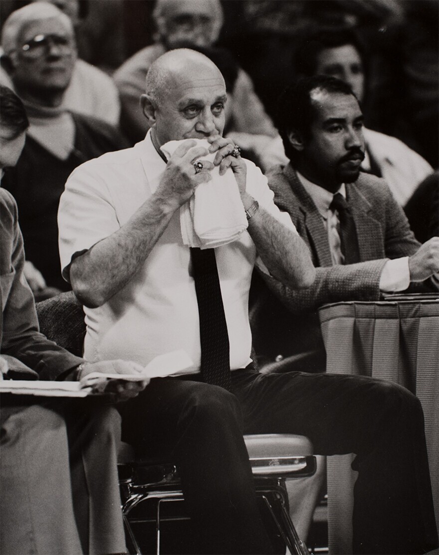 Basketball Coach Jerry Tarkanian 'chews' on his towel during a basketball game at the University of Nevada, Las Vegas (UNLV)