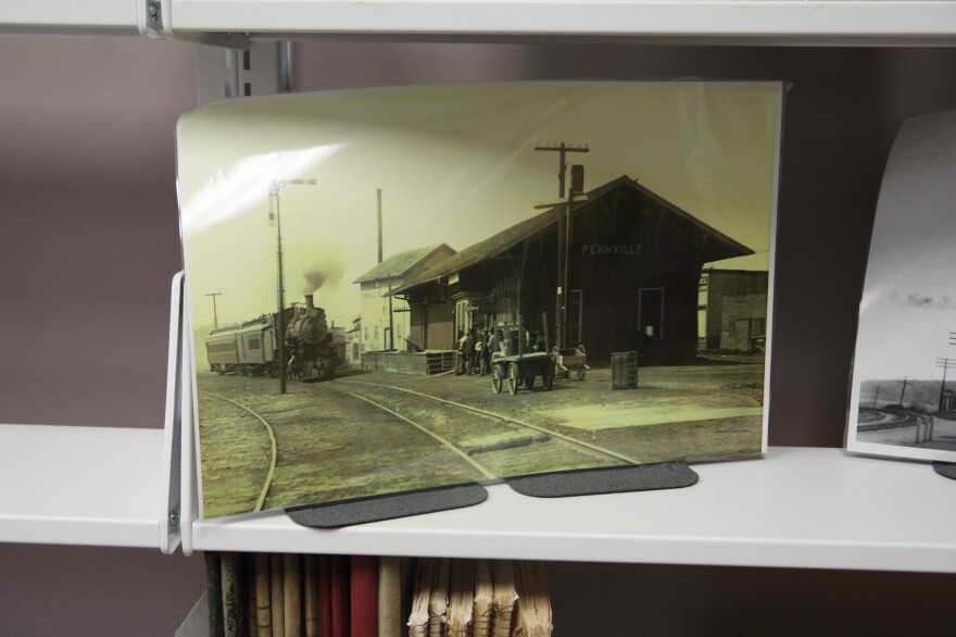 A historic photo of the Fennville train depot sits on a shelf in the library's local history and genealogy room.
