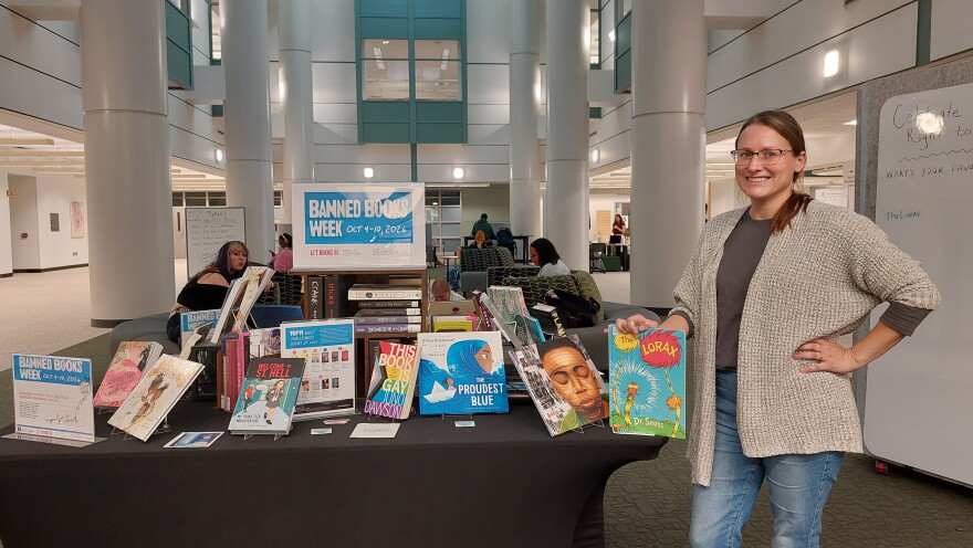 EMU STEM Librarian Kelly Getz stands in front of Halle Library's Banned Books Week display.