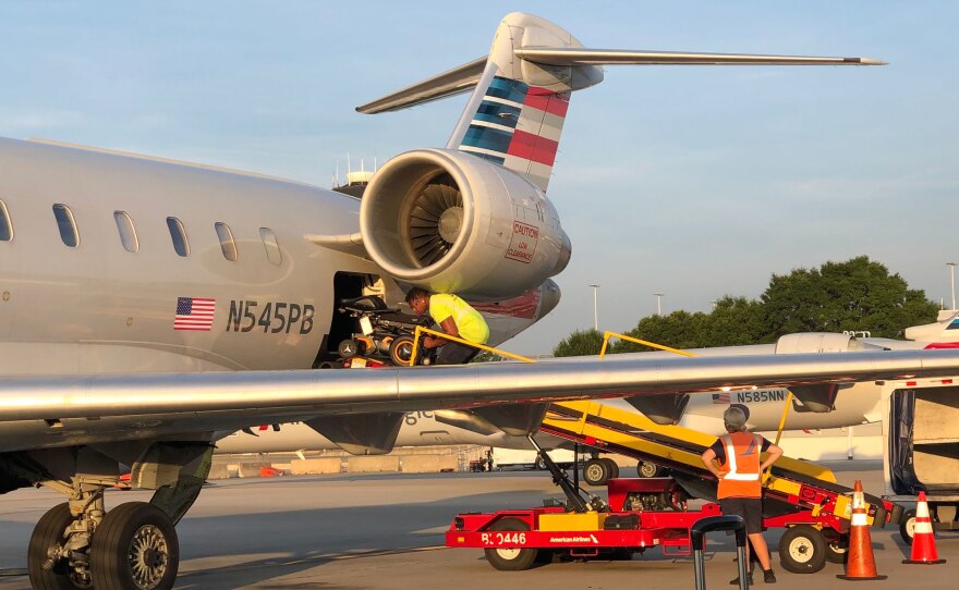 Morris' wheelchair is loaded onto an airplane.