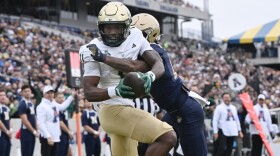 South Florida wide receiver Keshaun Singleton (11) catches a pass for a touchdown in front of Navy cornerback Justin Ross (17) during the first half Saturday, Nov .15, 2025, in Annapolis, Md.