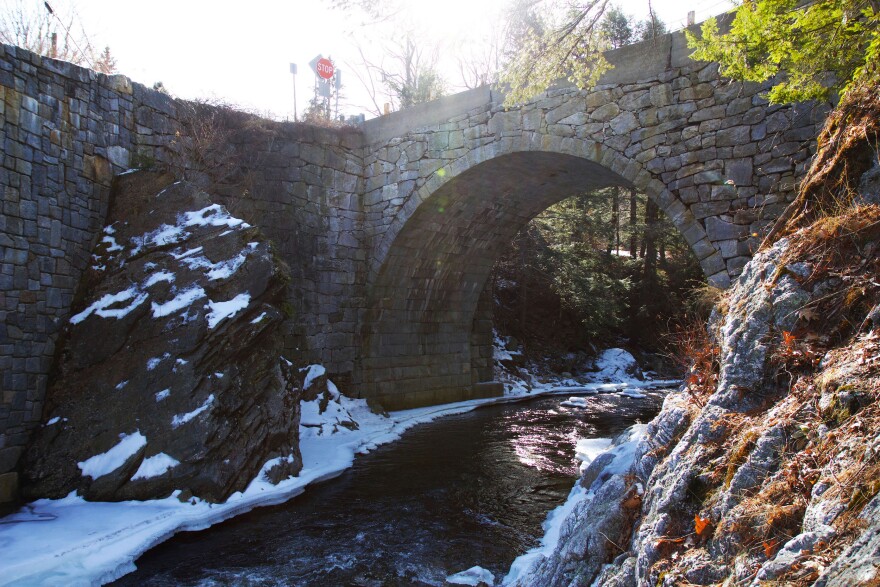 A stone arch bridge over a river.