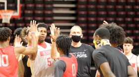 Basketball players gather in a huddle