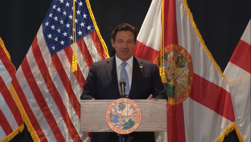 Gov. Ron DeSantis speaking at a press conference in Manatee County, Florida, on July 24, 2025. He stands behind a podium with the state seal on it.