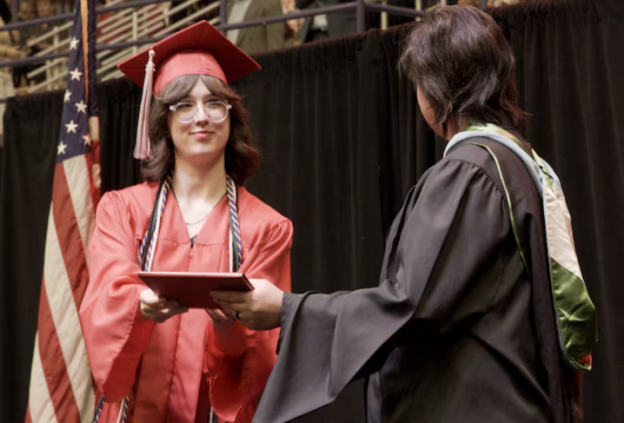 Ava, a student in OPB's Class of 2025 project, receives her diploma from David Douglas High School on June 5, 2025. In Oregon, 83% of students in the Class of 2025 graduated in four years.