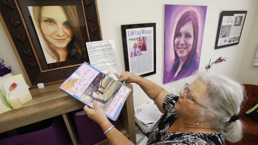 Susan Bro, mother of Heather Heyer, who was killed during the Unite the Right rally in August 2017, looks over memorabilia in her office in Charlottesville, Va., a year later.