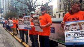 Union workers gathered outside the Statehouse Monday morning ahead of a rally against repeal of the common construction wage.