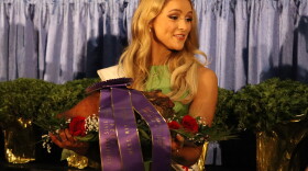 Miss Kentucky 2026 Reagan Earlywine parades around with the championship ham as bids flow in at the annual Kentucky Farm Bureau's charity ham auction.
