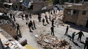 Journalists from foreign media based in Tehran document damage from U.S.-Israeli strikes in a residential area of the town of Fardis, west of Tehran, Iran, Friday, April 3, 2026. (Vahid Salemi/AP)