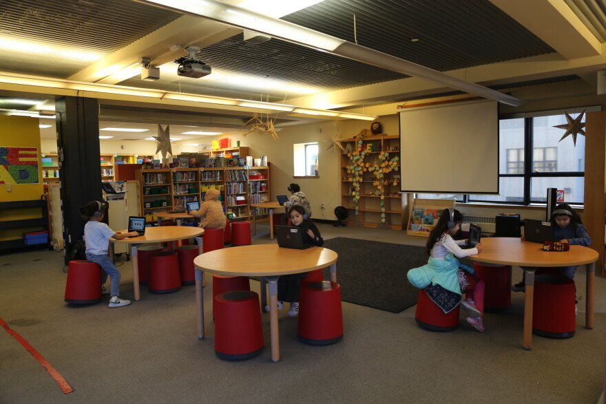 Elementary students practice reading with Amira Learning in the library at Tenderloin Community Elementary School. 