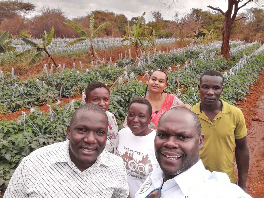 Noah Nasiali-Kadima, foreground, takes a selfie with members of the Africa Farmers Group during a tour of a member's farm in Machakos County, Kenya.