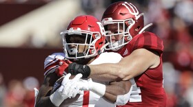 FILE - In this Oct. 12, 2019, file photo, Rutgers running back Isaih Pacheco, left, is tackled by Indiana linebacker Thomas Allen, right, during the first half of an NCAA college football game, in Bloomington, Ind. Allen had season-ending surgery on his left shoulder in November. His recovery plan changed dramatically when the coronavirus pandemic led to the suspension of athletic activities.