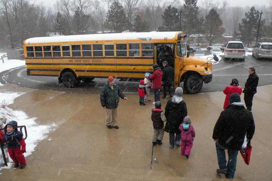 kids going to a school bus