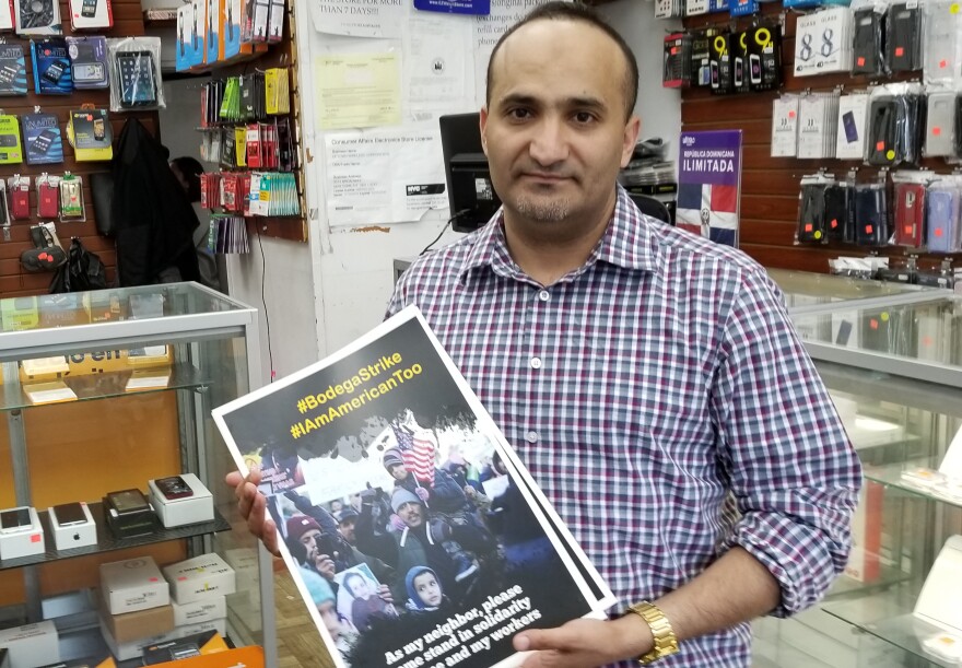 Zaid Alnagi with New York City's Yemeni-American Merchants Association delivers posters for the association's protest on Tuesday.