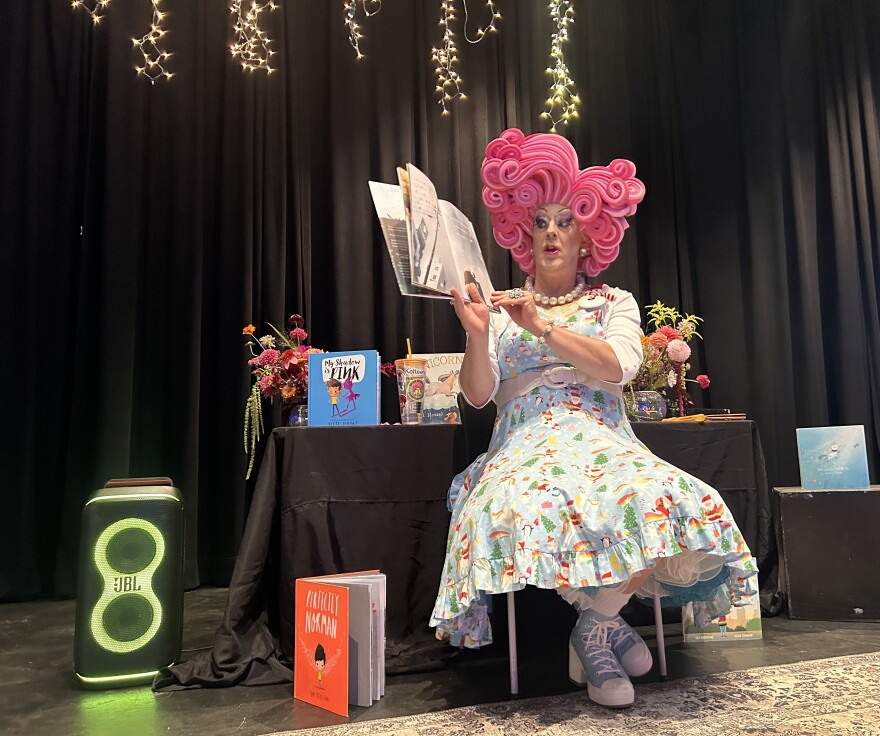 Miss Shirley reading at book at the drag queen story time in Gunnison.