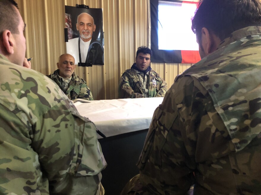 Maj. Jason Moncuse, back to camera on left, meets with actors portraying Afghan village officials. The training exercise at Fort Polk, La., is preparing the 1st Security Force Assistance Brigade for a spring deployment to Afghanistan.