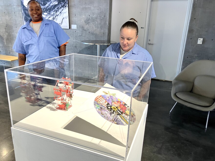 Stephanie Glenn (left) and Kristan Bissell admire a piece made by another incarcerated woman on Thursday, July 6, 2023