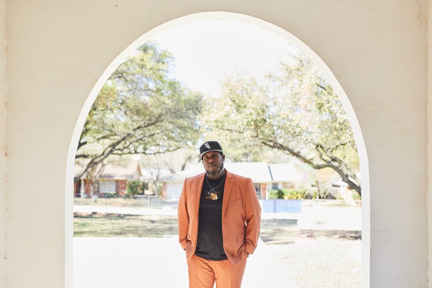 Thomas Mayfield poses at the entrance of J. T. Stevens Elementary School.