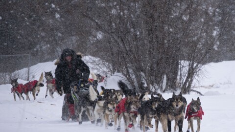 Jason Mackey leaves the Fort Yukon checkpoint with his son, Jason, behind him. (Herbert/KUAC)