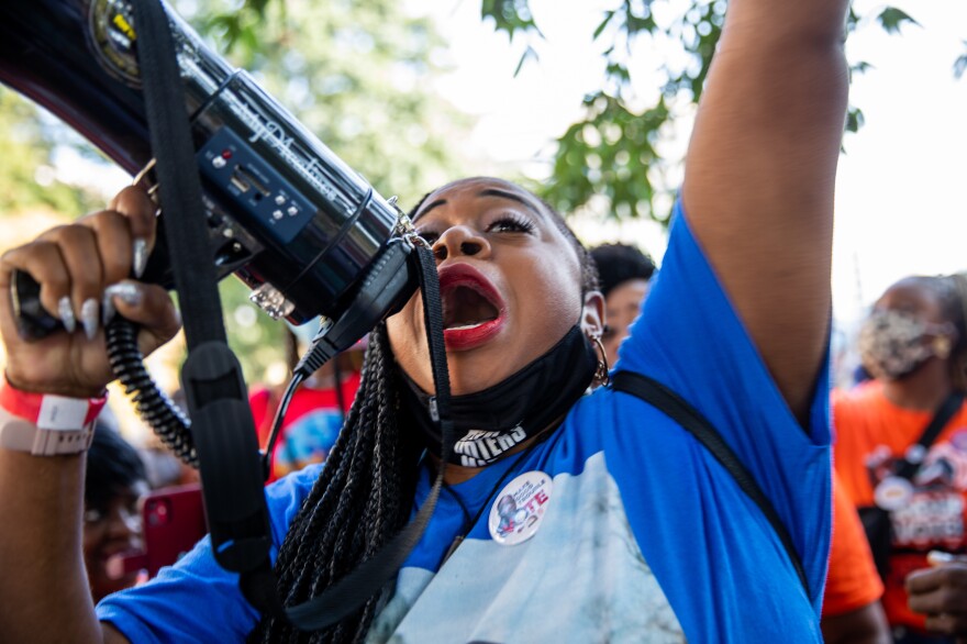 Members of the Atlanta NAACP cheer in McPherson Square during the march pre-rally.