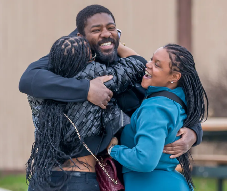Roy Blackmon is hugged by family members after his release from prison Tuesday. Blackmon served 27 years for a 1998 murder her didn't commit.