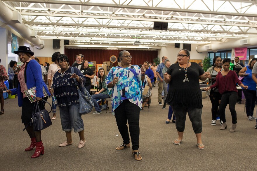 Students, teachers and community members break into the "Electric Slide" during the Spring Fair.