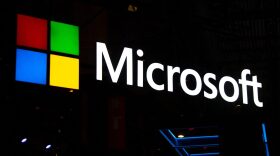 A logo sits illuminated outside the Microsoft booth on day 2 of the GSMA Mobile World Congress 2019 in Barcelona, Spain.