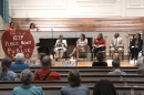 Guilford democratic representatives sit on stage at a town hall about public school funding