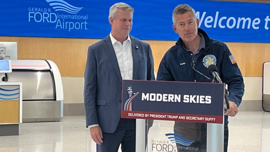 Congressman Bill Huizenga looks on as U.S. Transportation Secretary Sean Duffy speaks at Grand Rapids' Ford Airport Wednesday