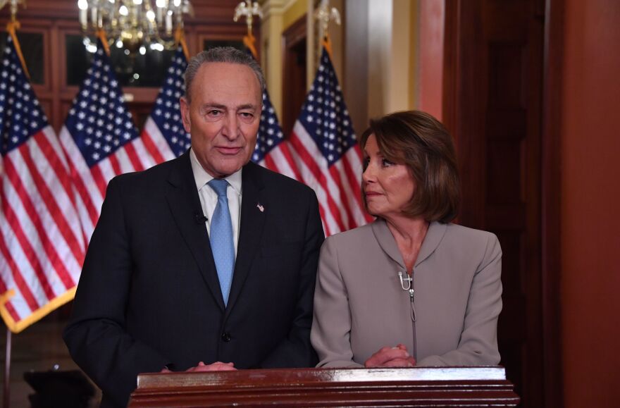 House Speaker Nancy Pelosi and Senate Democratic leader Chuck Schumer pose for pictures after delivering a response to President Trump's televised address to the nation.