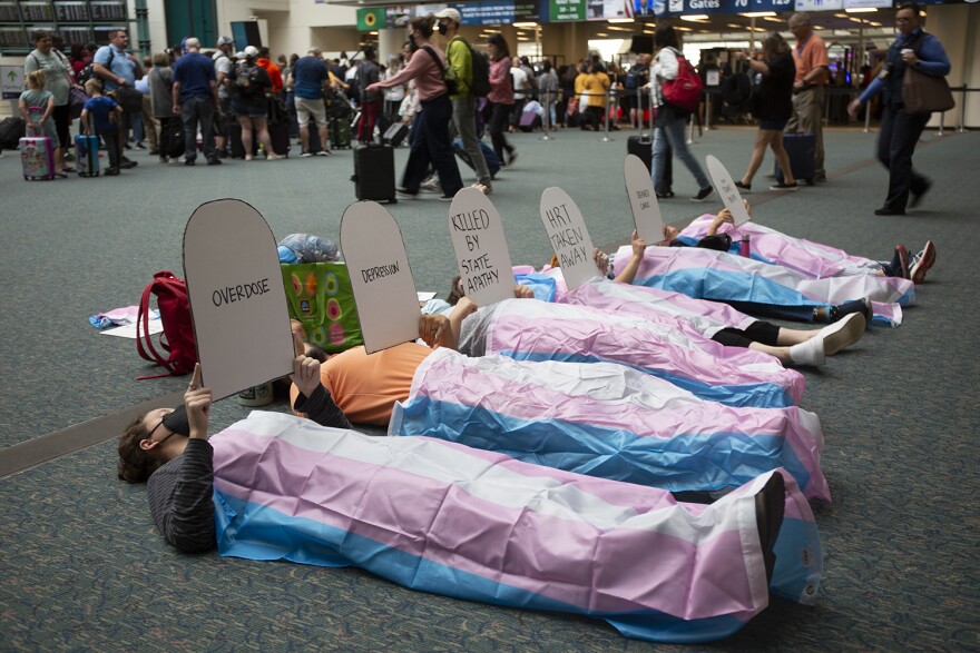 Trans advocates staged a "Die-In" at the Hyatt Regency Hotel at Orlando International Airport.