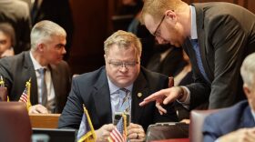 Rep. Mike Speedy, R-Indianapolis, checks his phone on the House floor.