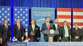 vp at a podium surrounded by signage about eliminating SNAP fraud