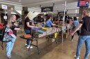 Volunteers from Enclave stuff backpacks for this year's United Way of Cass-Clay's school supply drive.