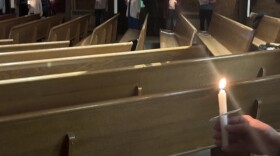 People gathered at a church on election night 2024 for a candlelight vigil.