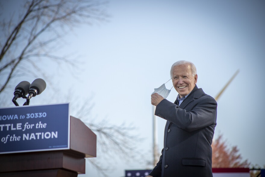Democratic Presidential Nominee Joe Biden takes his mask off before speaking at a drive-in campaign rally at the Iowa State Fair on Friday October 30, 2020.