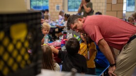 Spanish Immersion School Principal Michael Brennan talks to students during lunch at the K-8 school in Mansfield.