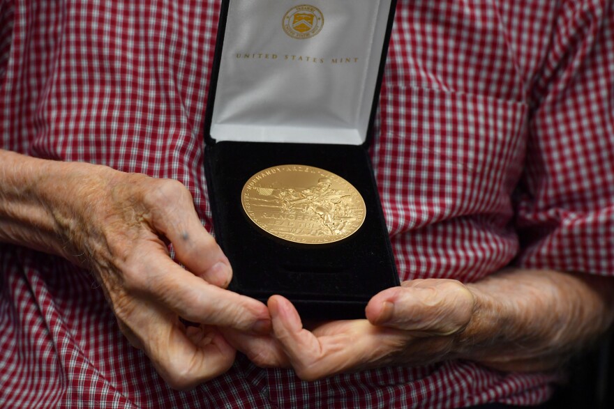 Sgt. Joseph Drake holds his Congressional Gold medal. The medal reads "Rangers Lead the Way." The motto was earned during World War II, according to the U.S. Army.