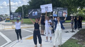 Friends and family of Claudia Carolina Rodriguez Caglianone wave signs outside of the Broward Transitional Center, a for-profit detention facility funded by U.S. Immigration and Customs Enforcement (ICE) in Pompano Beach.