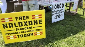 Signs are displayed at a tent during a health event. As the number of U.S. overdose deaths continues to soar, states are trying to take steps to combat a flood of the drug that has proved the most lethal -- illicitly produced fentanyl.